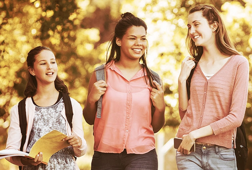 Three secondary school pupils walking together