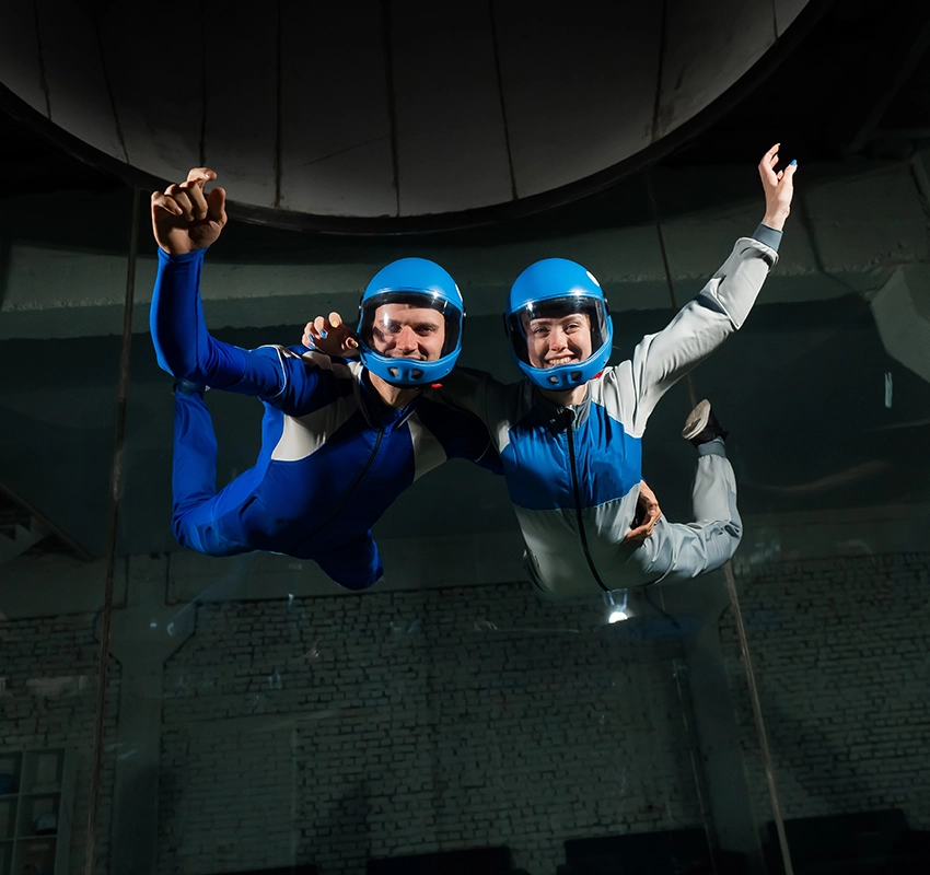 Two people indoor skydiving