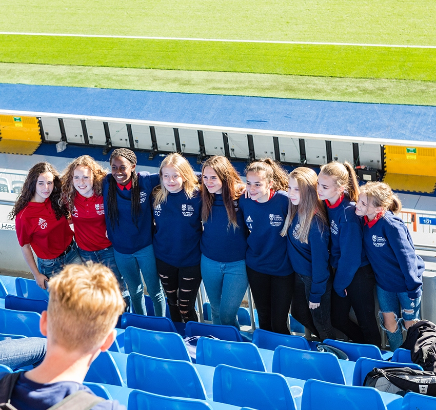 A school group posing for a photo at real madrid stadium