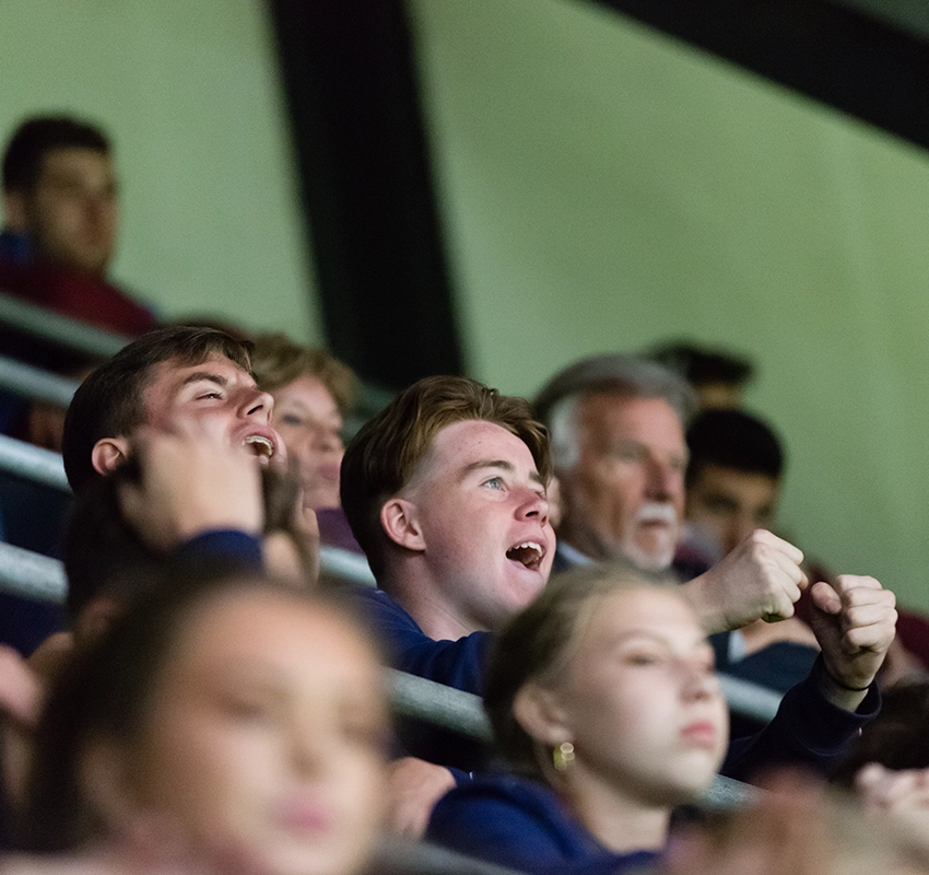 Young boy watching a live football match at a stadium