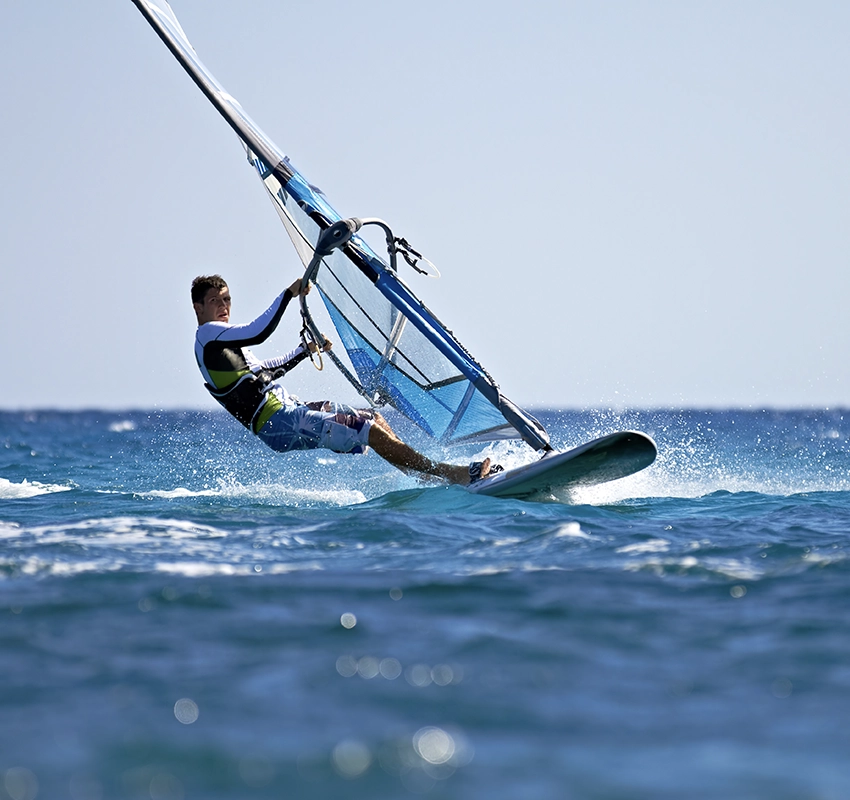 A person windsurfing in the ocean