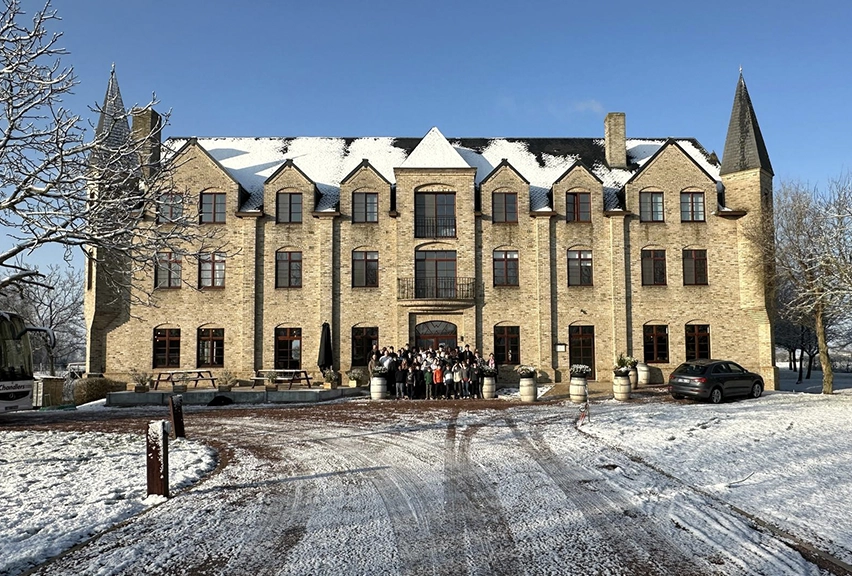School group in front of hotel on a snowy day
