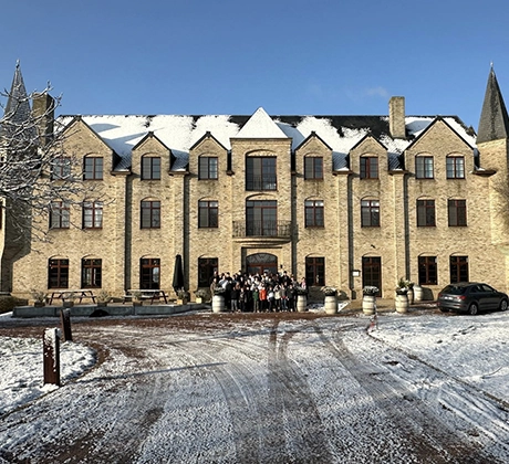 School group in front of hotel on a snowy day