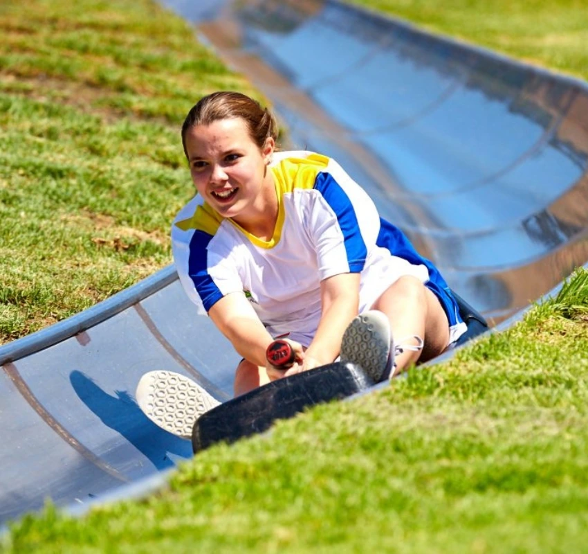 Girl sliding down toboggan run