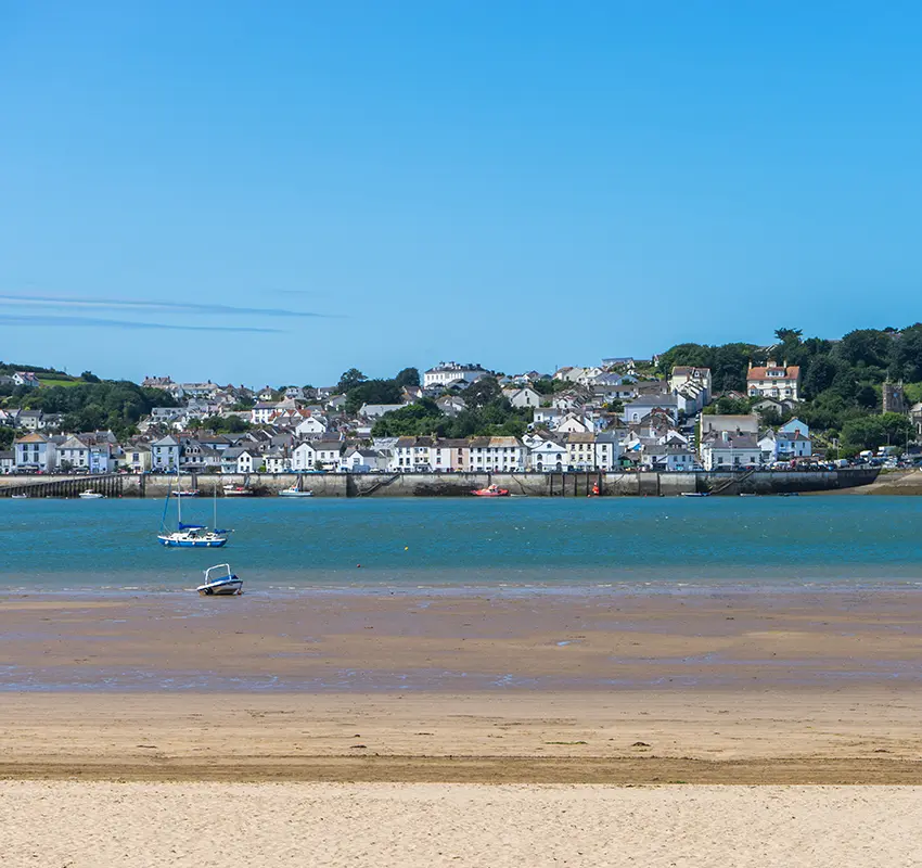Scenic view of coastal town from across a beach