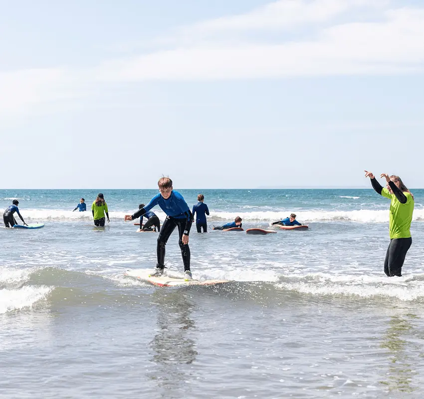 A group of young people in a surfing lesson