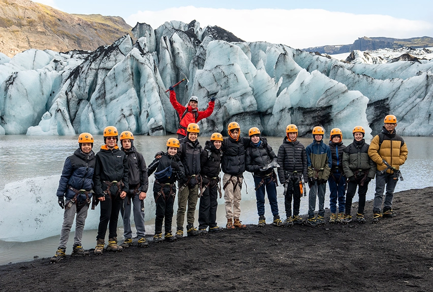 A school group standing in front of a glacier in Iceland