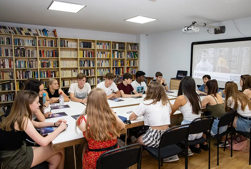 Students grouped at a table in a language lesson