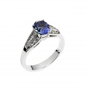 Close-up on a white background of a white gold ring with a Tanzanite
