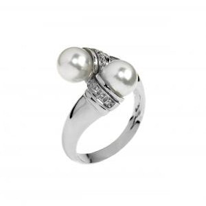Close-up on a white background of a silver crossed ring with two pure pearls.