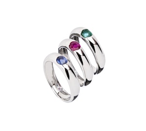 Three band rings with color stones on a white background