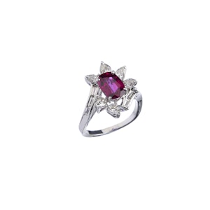 Ring with ruby and fancy-cut diamonds on a white background