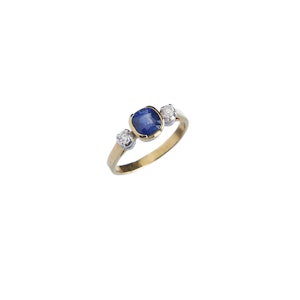 Yellow gold ring with sapphire on white background
