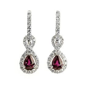 A couple of gold and gemstone earrings on a white background.