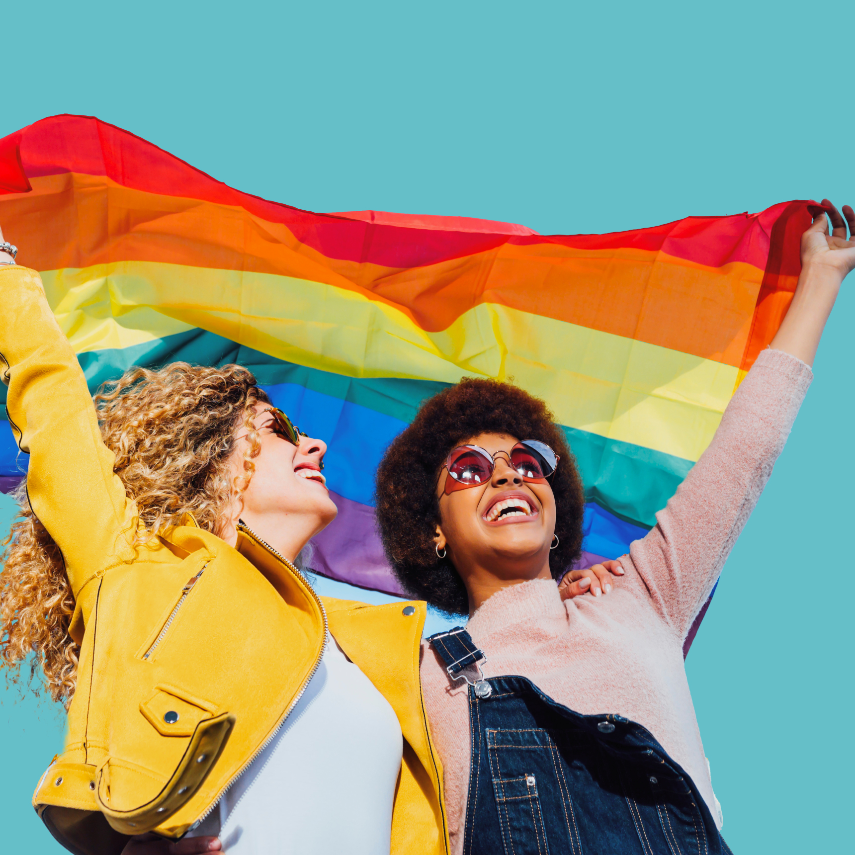 Two women holding rainbow flag