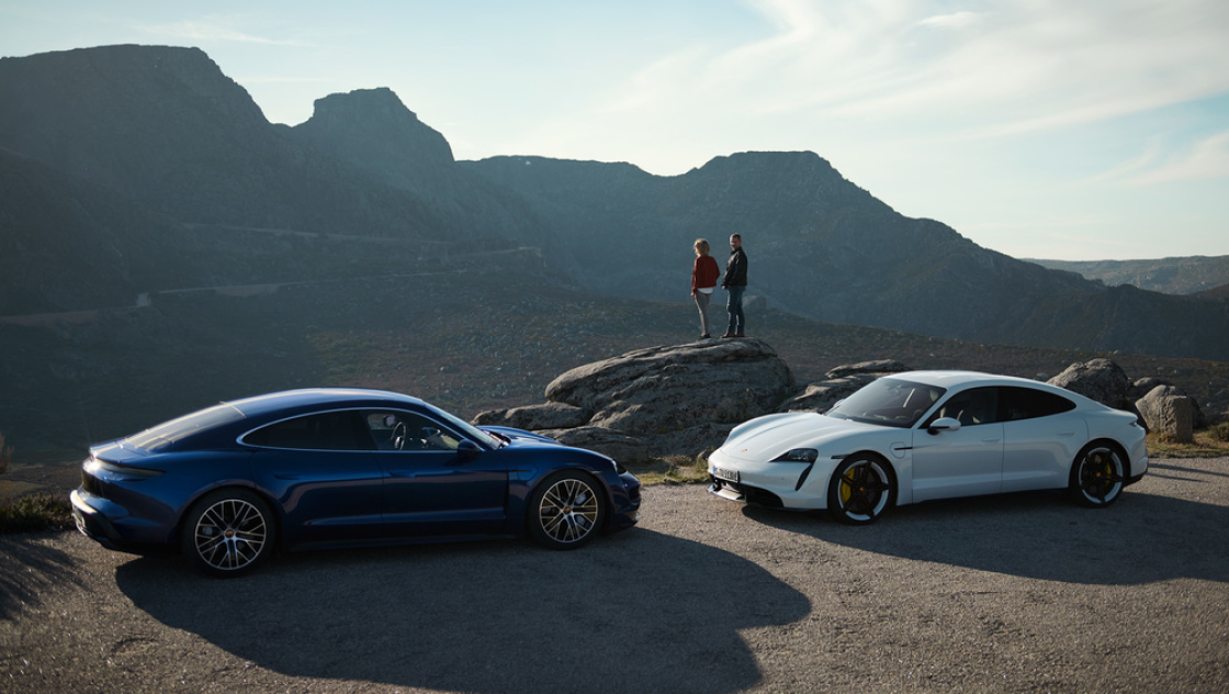 Porsche cars parked by cliff