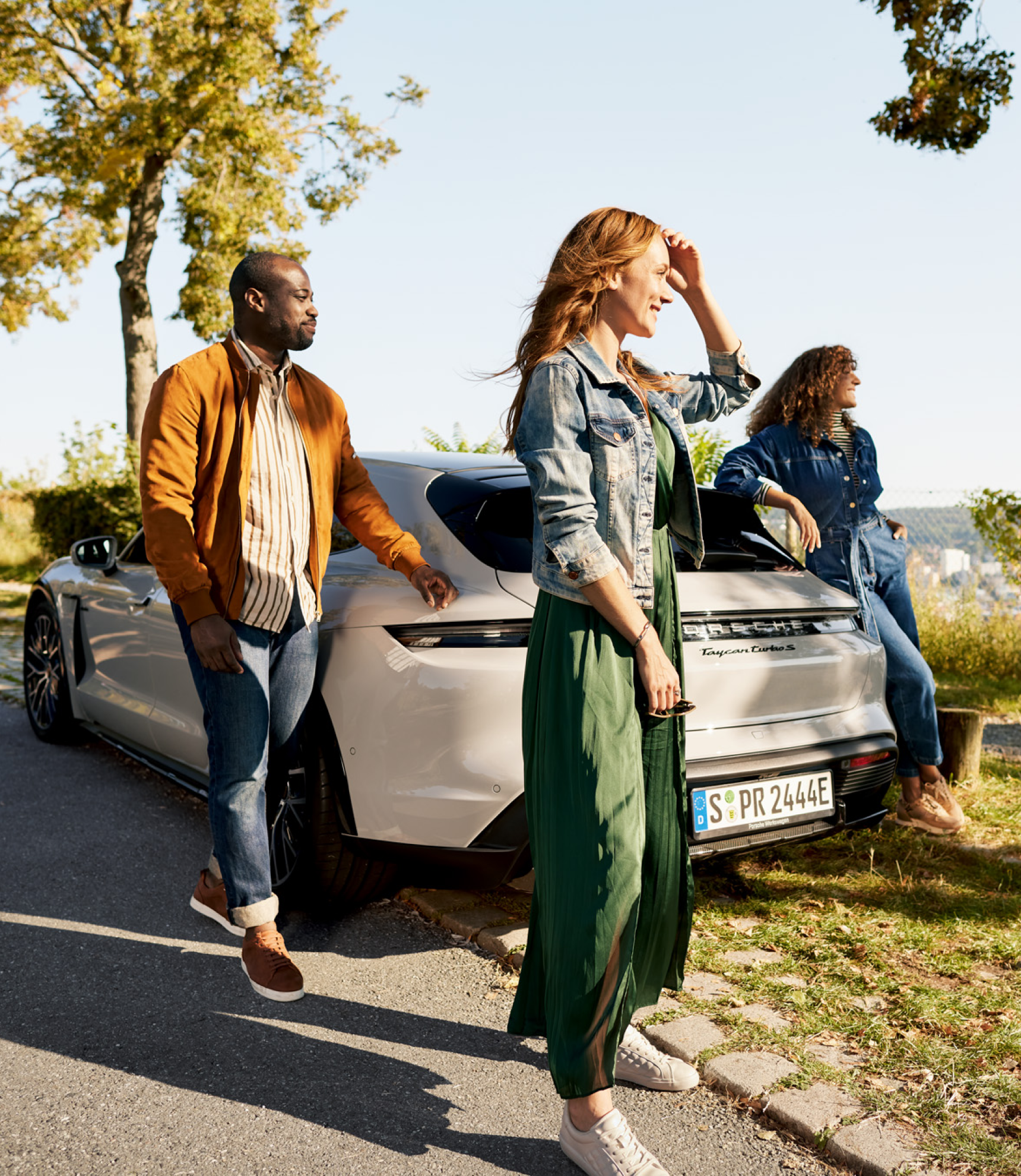 People standing around Porsche