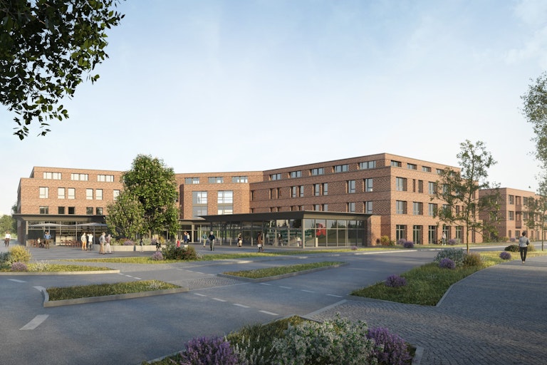 You can see a photo of the facade of the wohnvoll village Bergkamen. It is a modern building in brown color and a glazed front on the first floor.