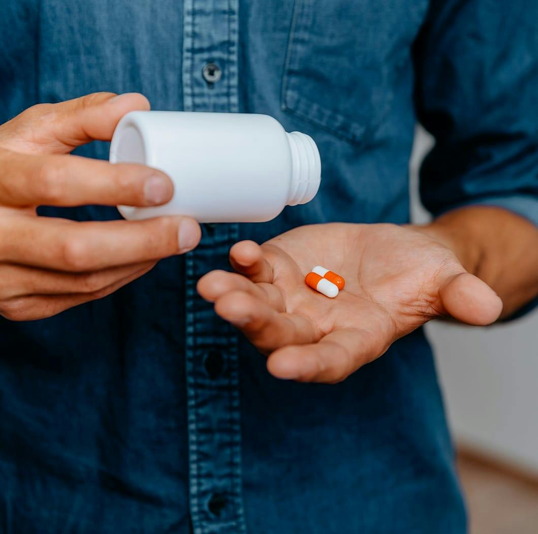 Man with two pills in his hands