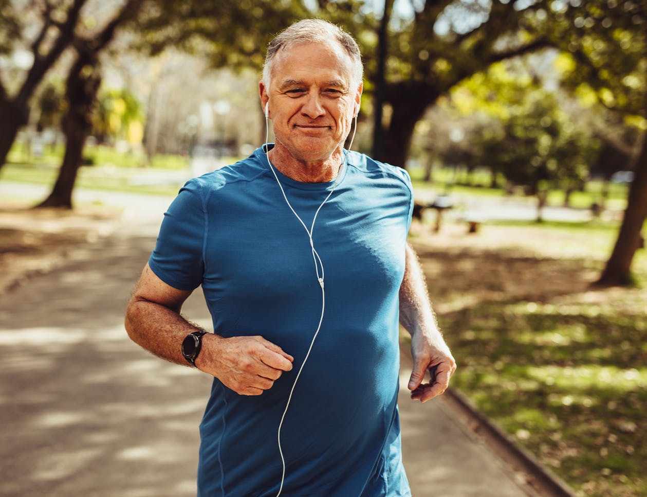 Man jogging on a shaded sidewalk