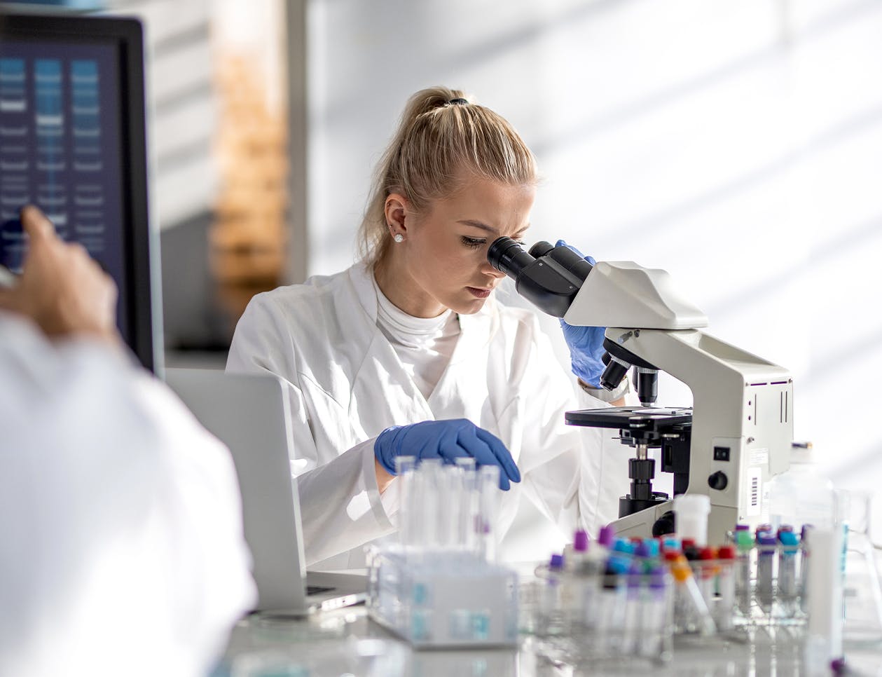 Doctor looking through a microscope