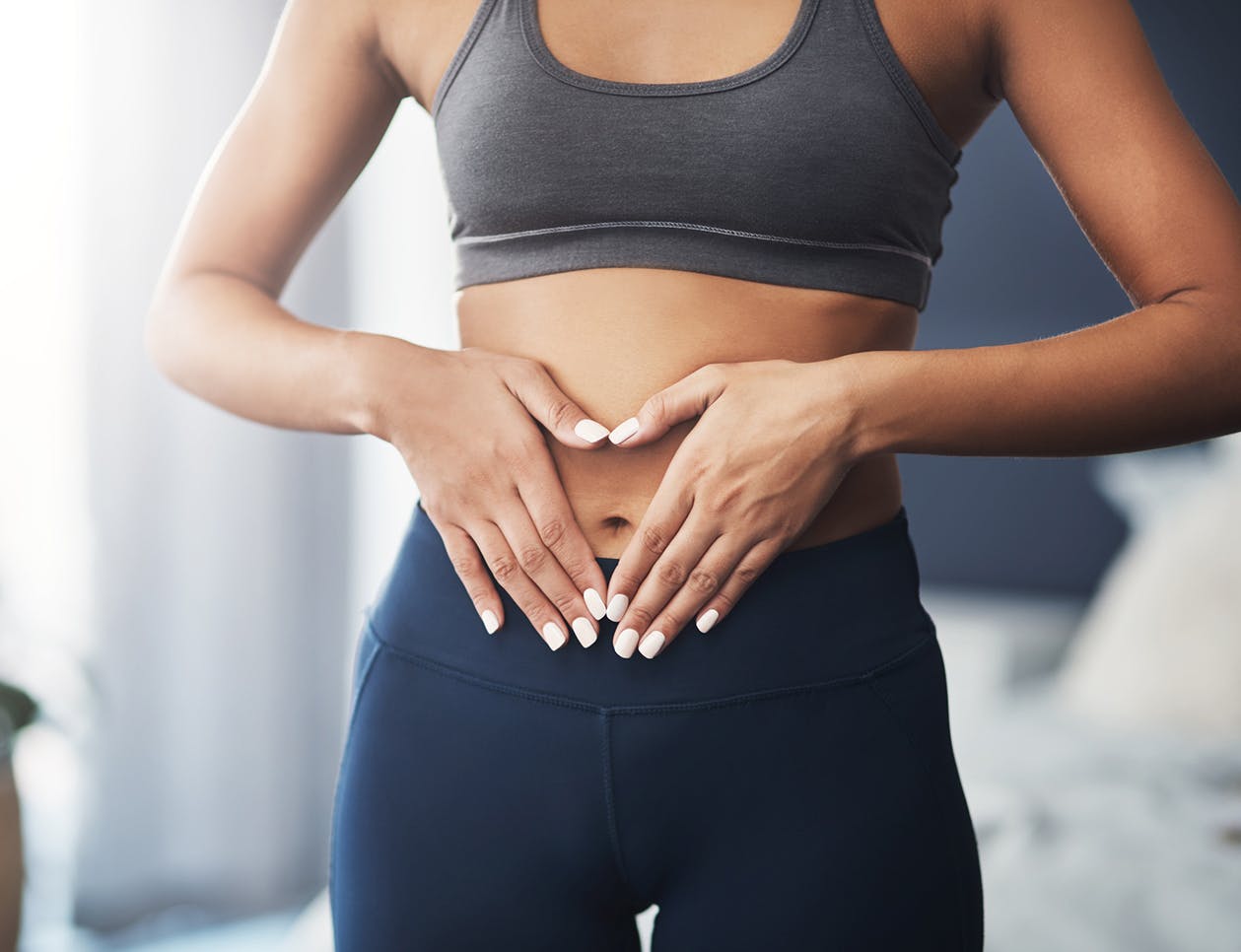 Woman with her hands over her stomach