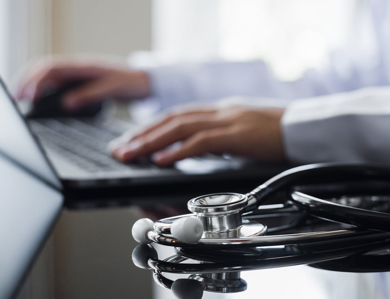 Doctor sitting at a computer