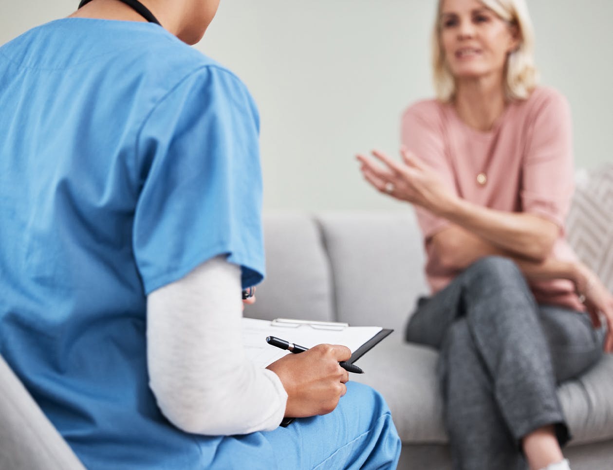 Woman sitting talking to a doctor