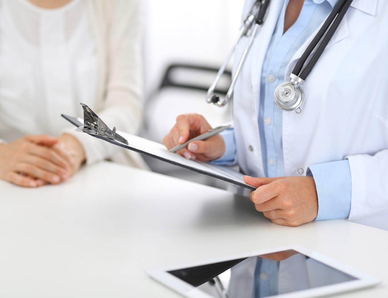 Doctor writing on a clipboard