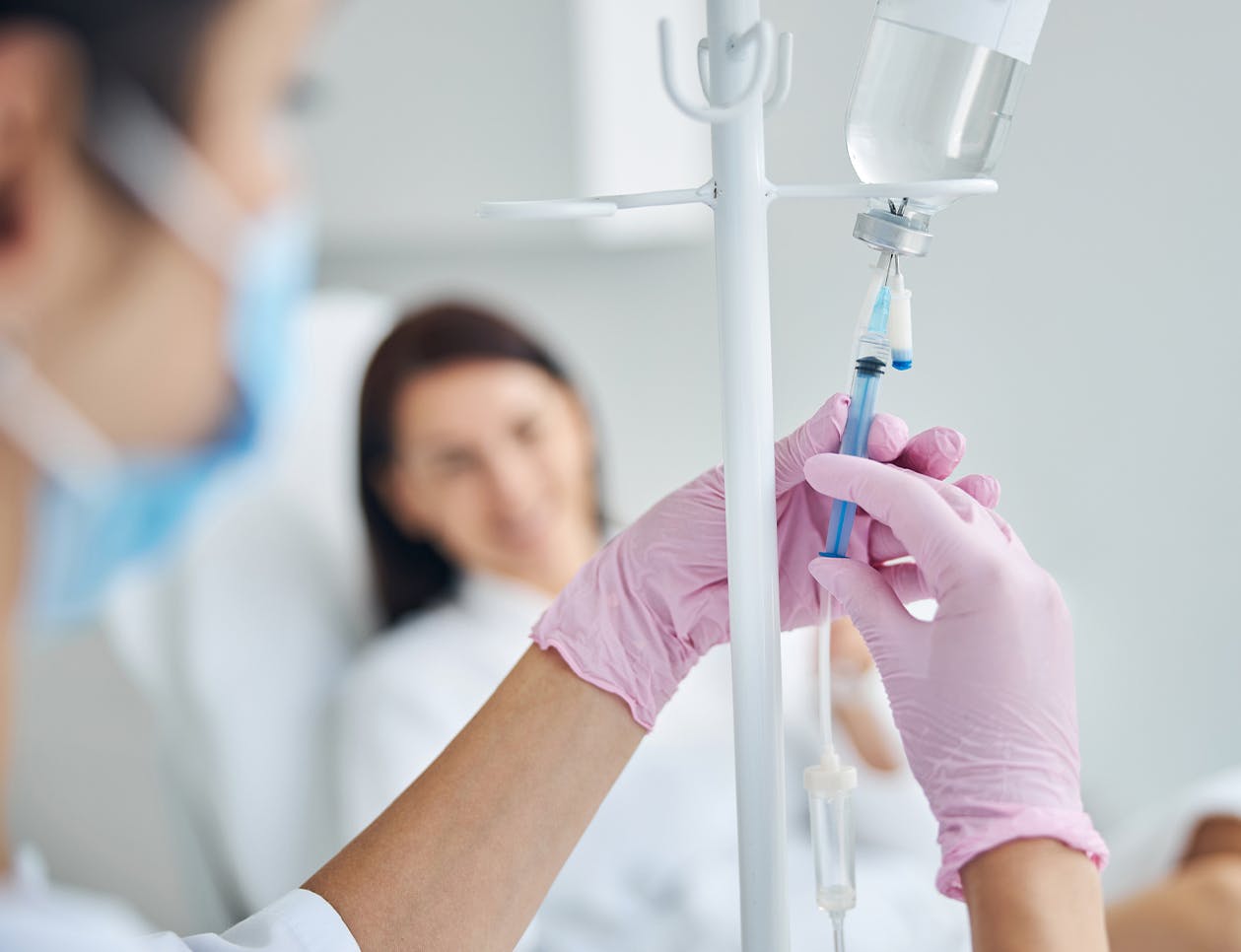 Doctor injecting into IV bag