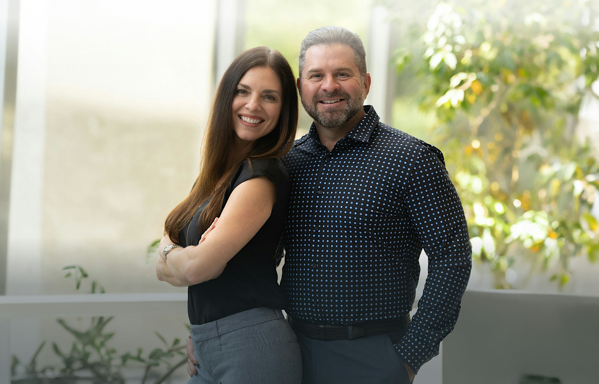 Man and woman in front of a window