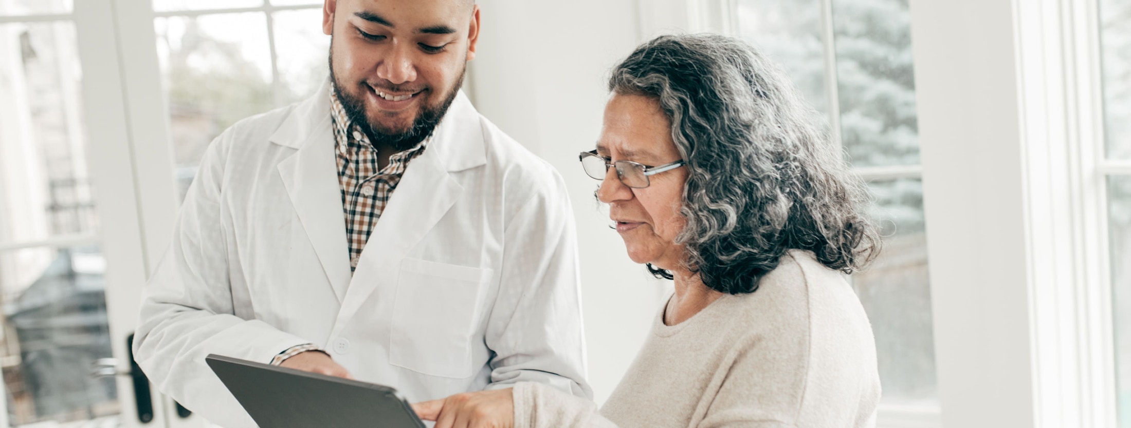 Doctor going over medical chart with patient 