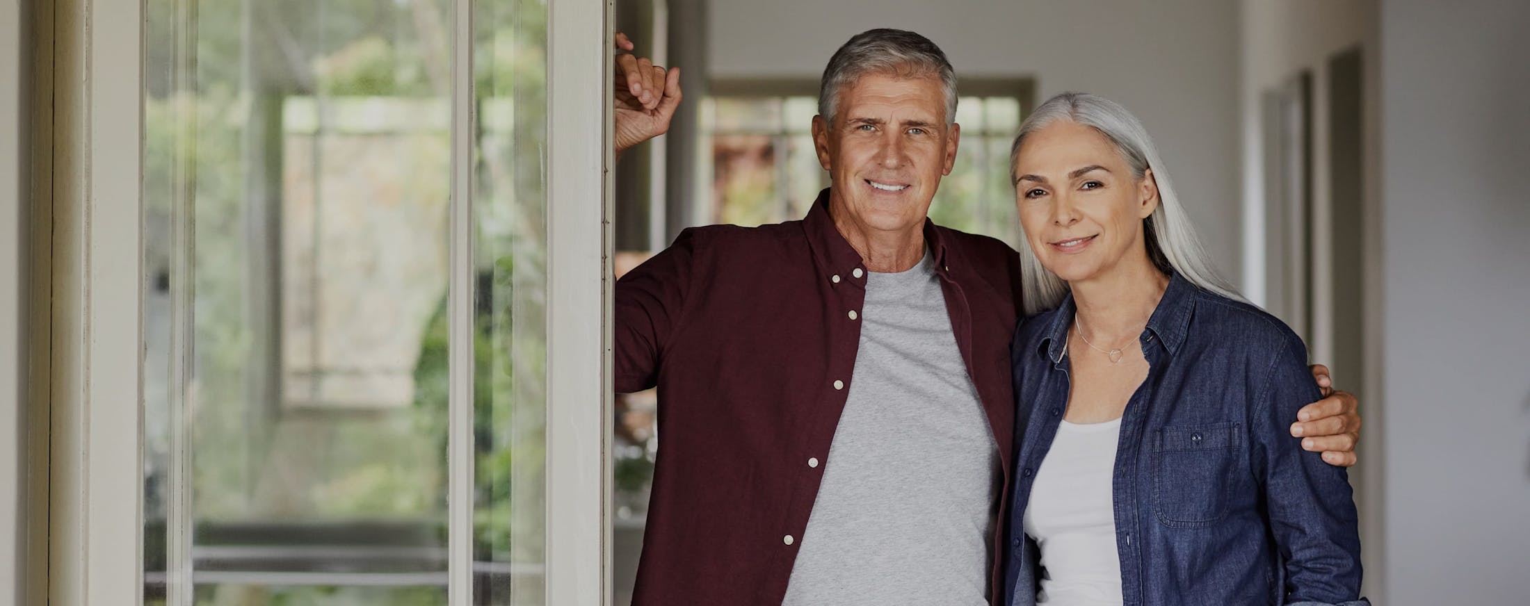 Middle aged couple standing together, smiling 