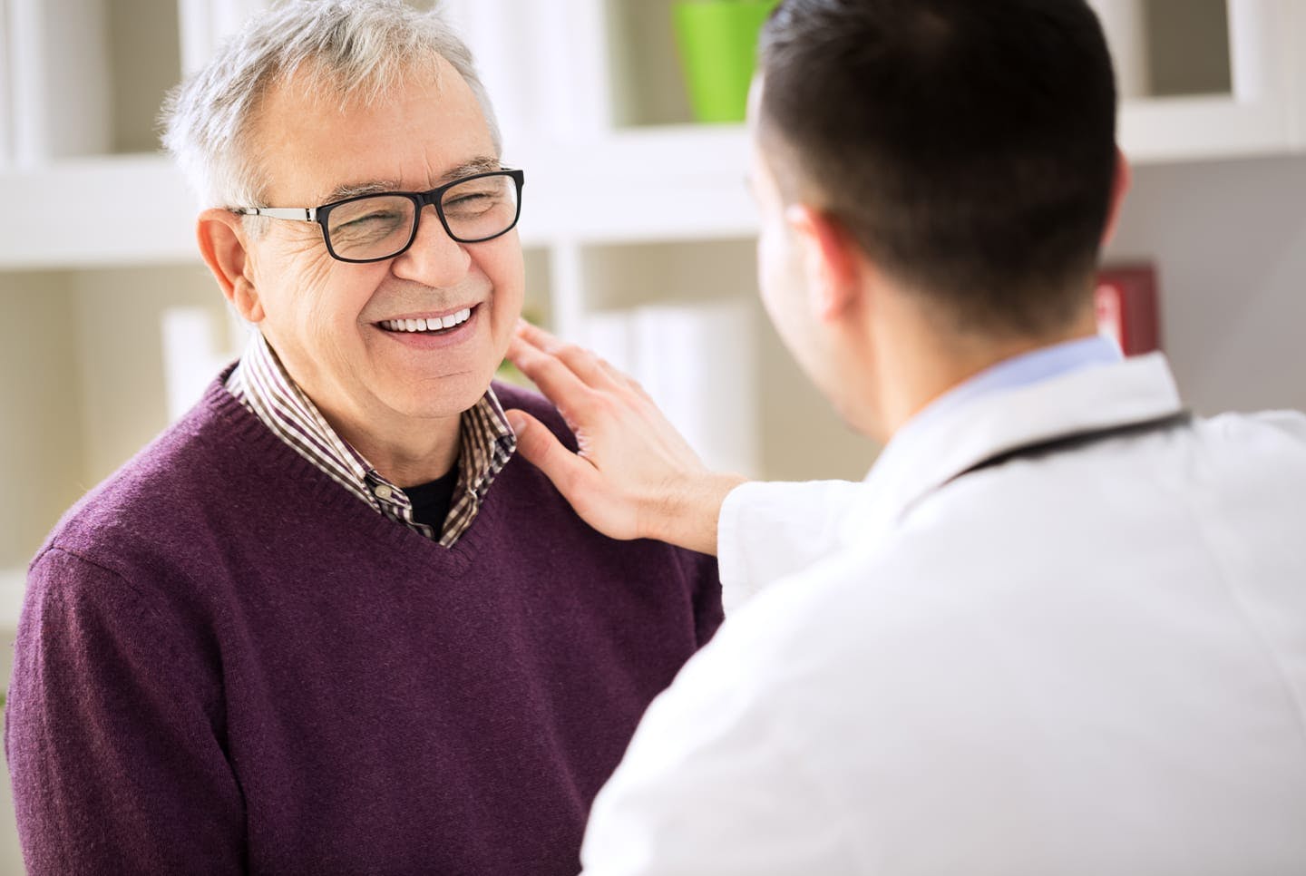 Doctor speaking with older male patient