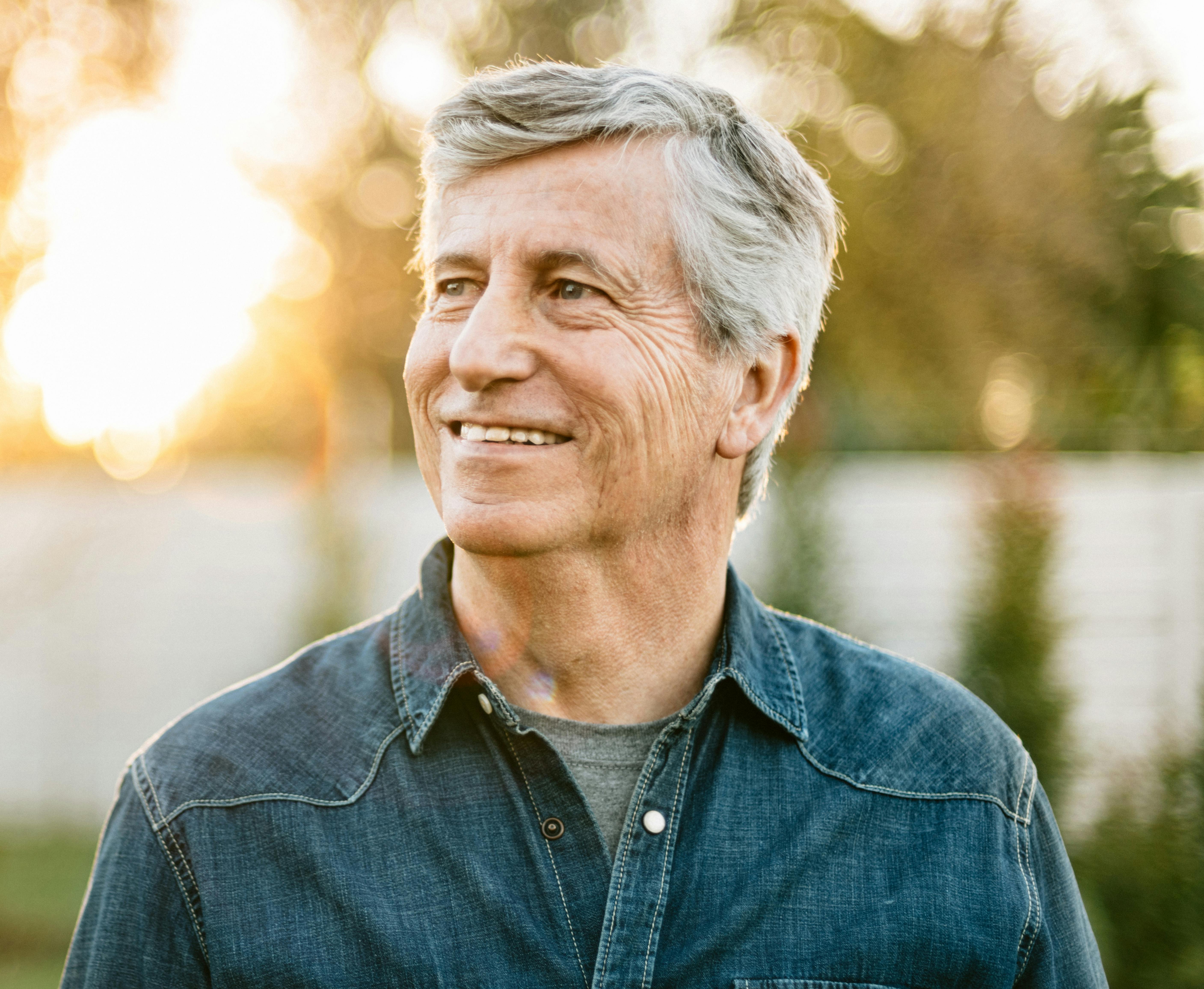 Handsome older man smiling, looking to the side