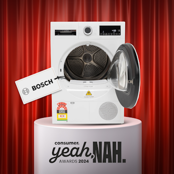 Bosch dryer on plinth in front of red curtain.
