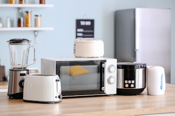 A group of kitchen appliances on a kitchen bench.