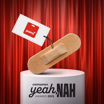 Pams plaster on Yeah Nah Awards plinth in front of red curtain.