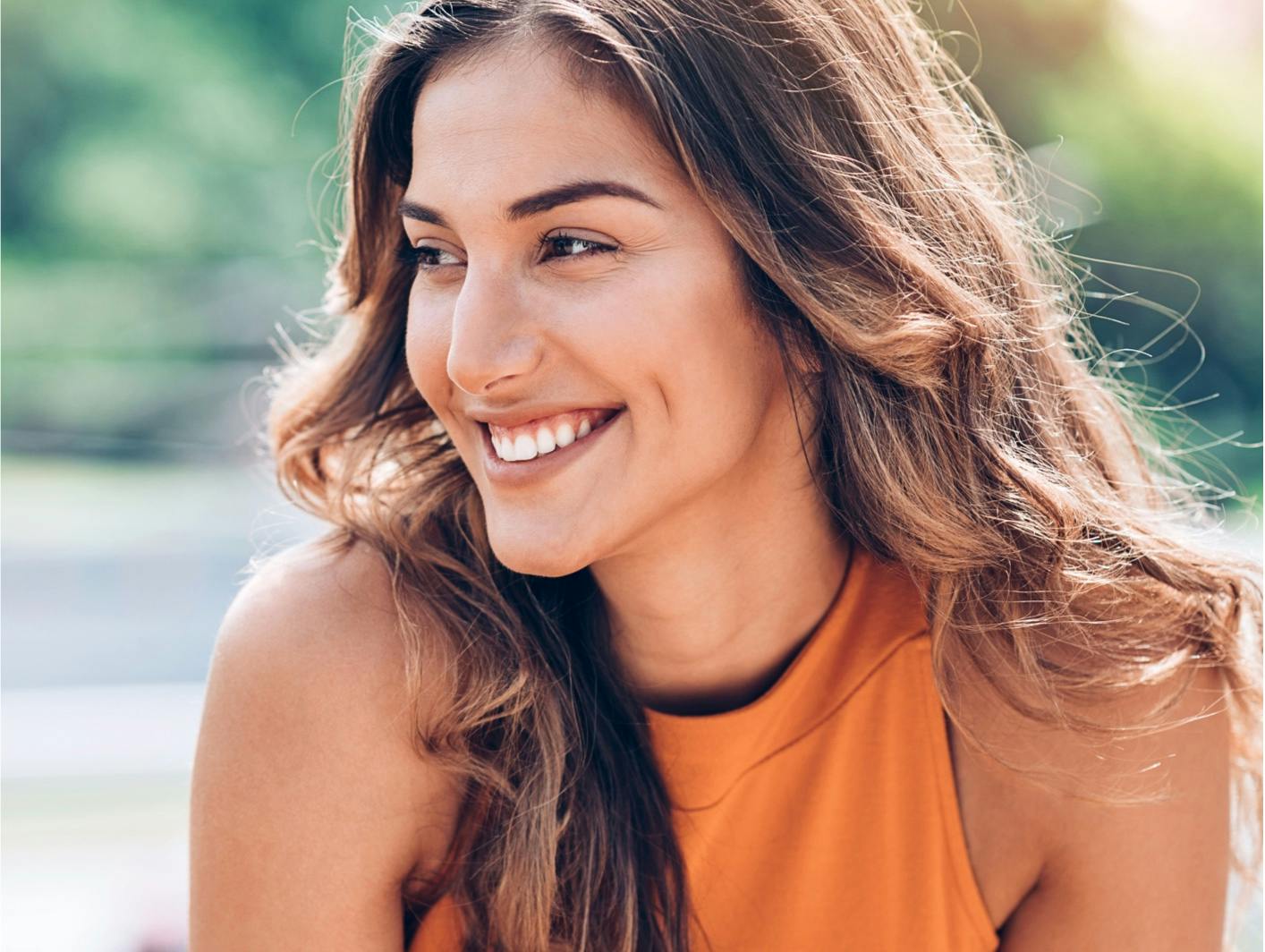 Attractive woman smiling showing dermal fillers in Upper East Side.