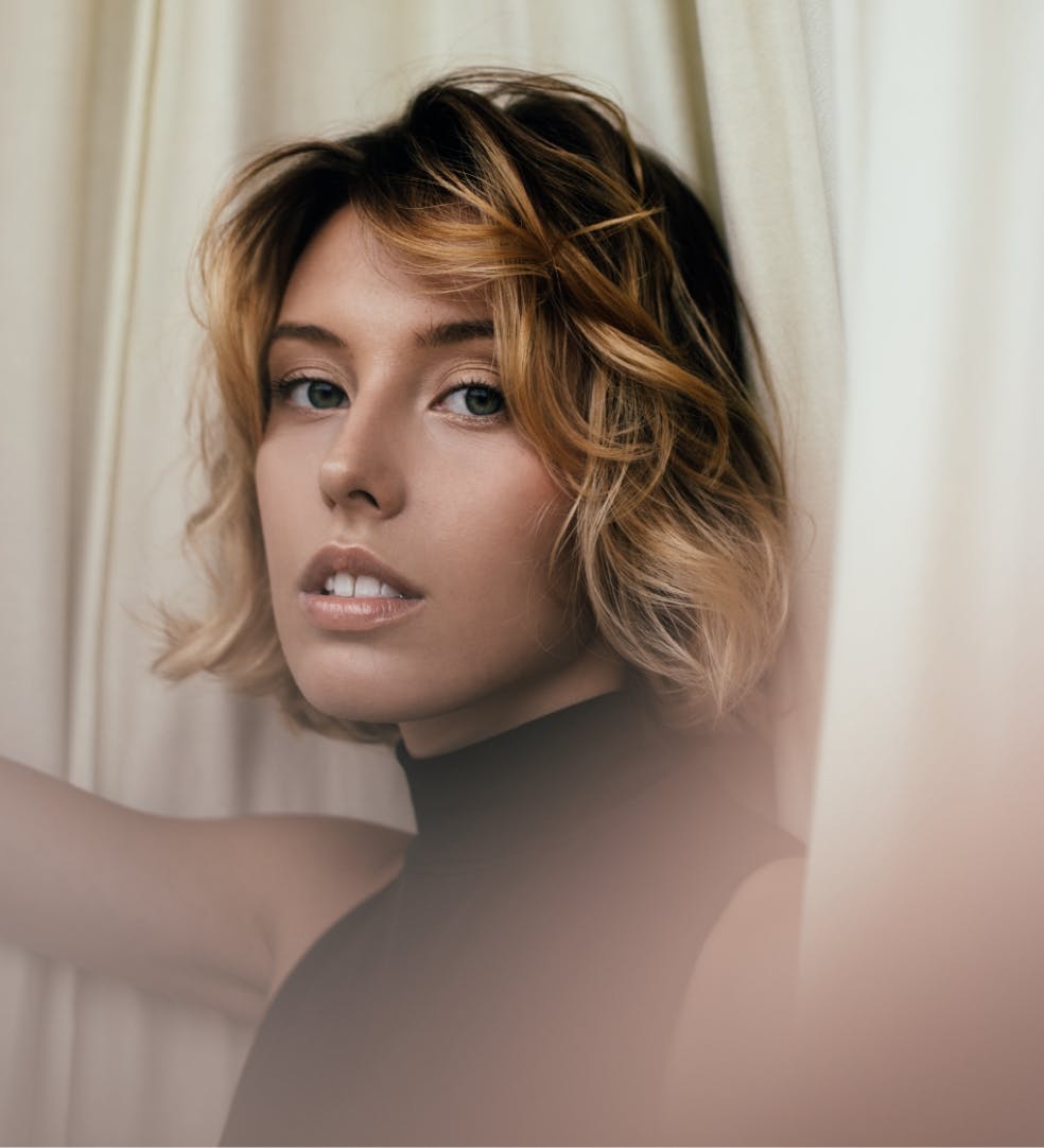 Beautiful model in black looking at camera.