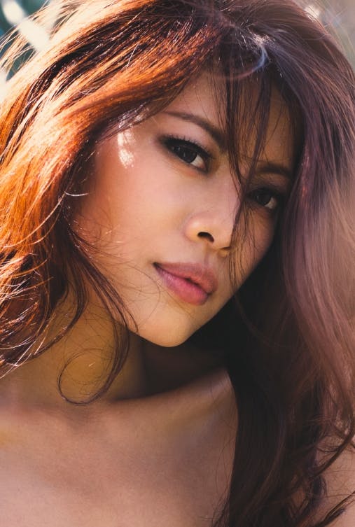 attractive woman with brown hair looking at camera