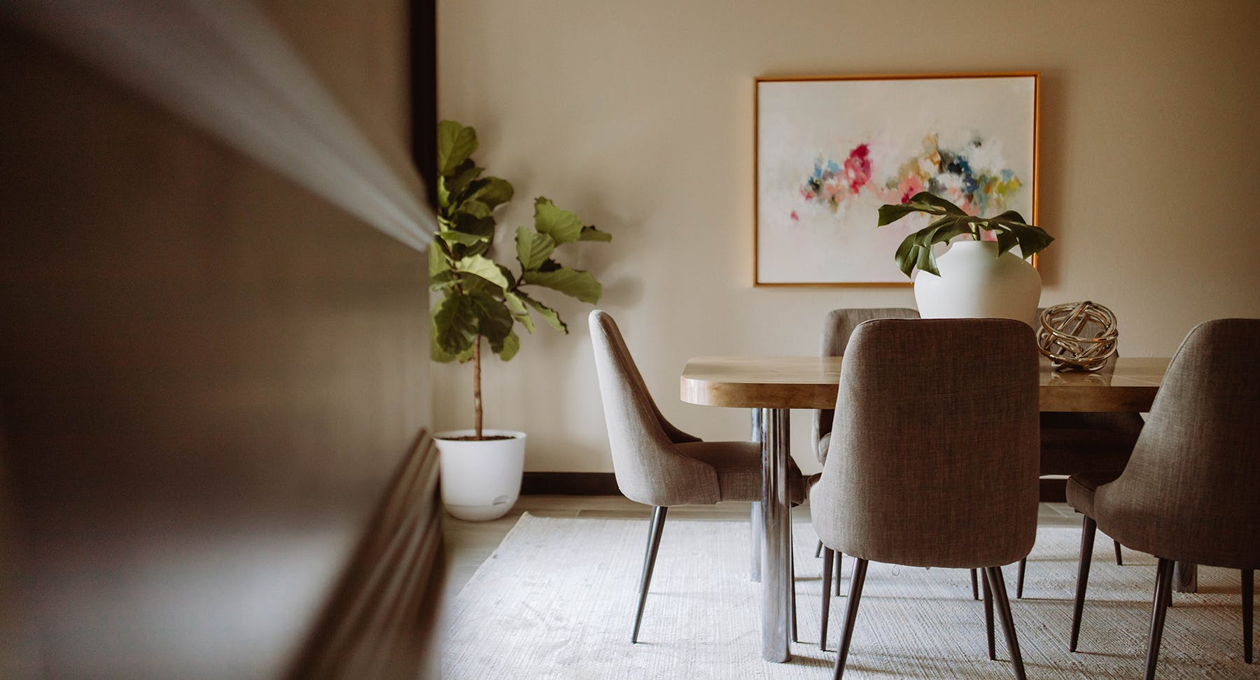 Classic beige office conference room with art and plants.