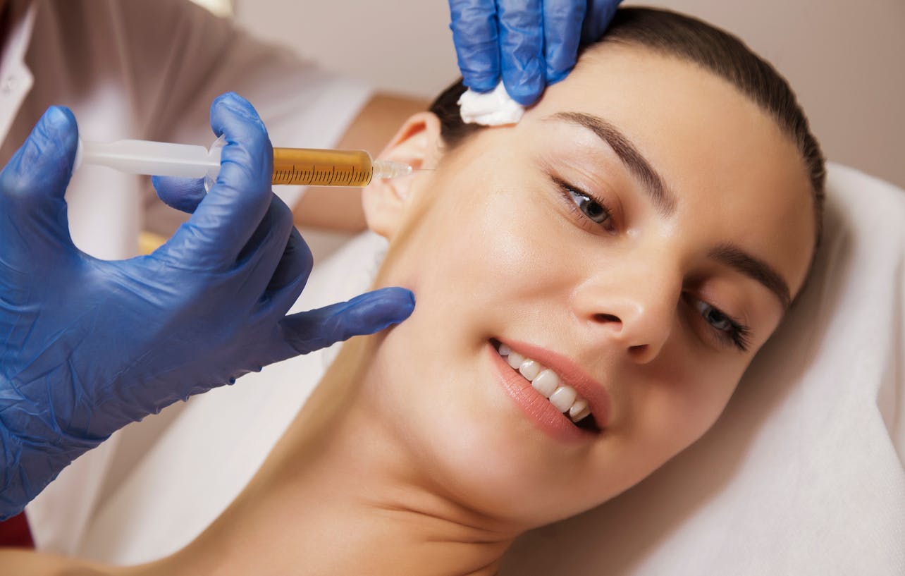 woman getting injected on face
