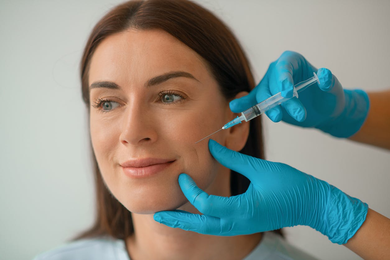 woman getting injected on face