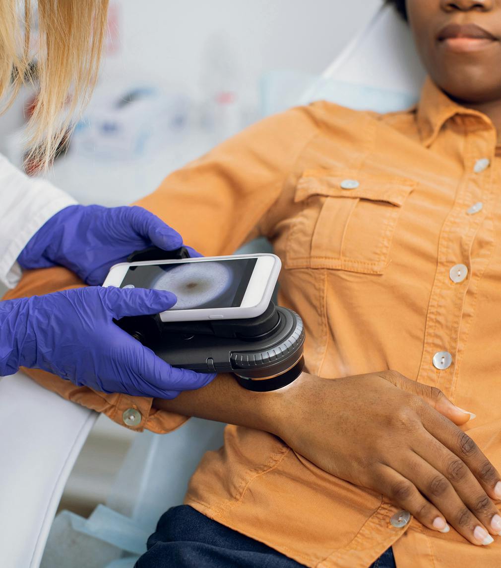 Woman receiving treatment on her hand from a doctor