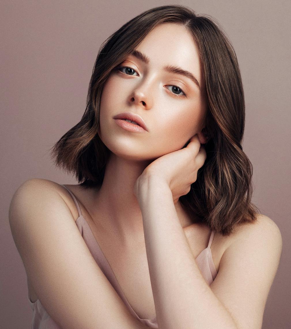 Woman posing with her hand on her neck