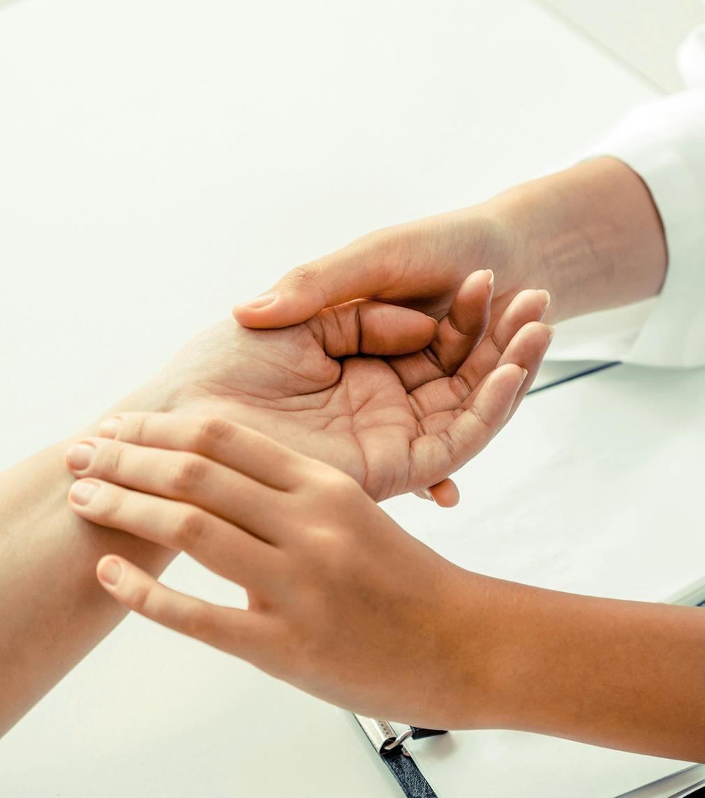 Doctor looking at a patients hand