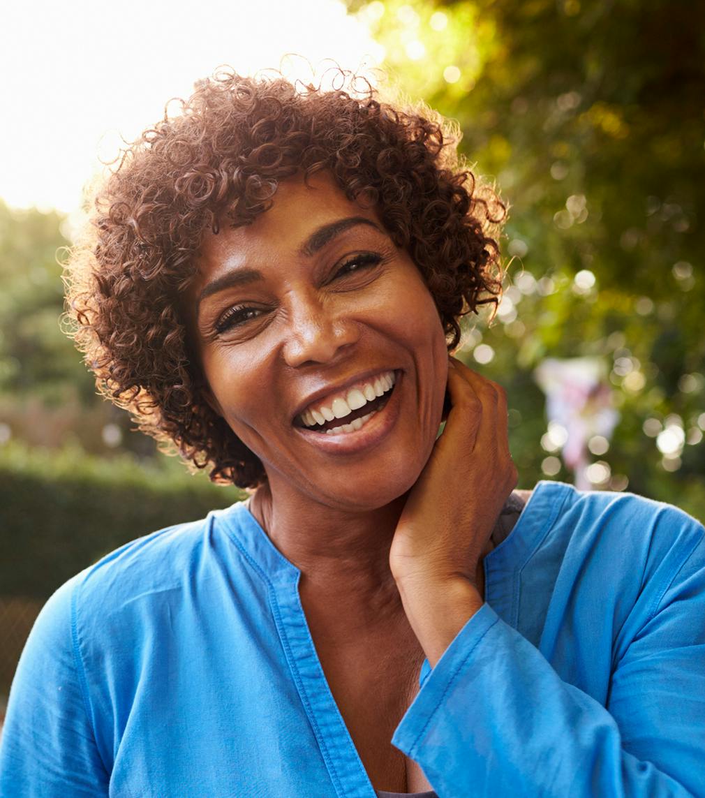 Woman in a blue shirt with her hand on her cheek