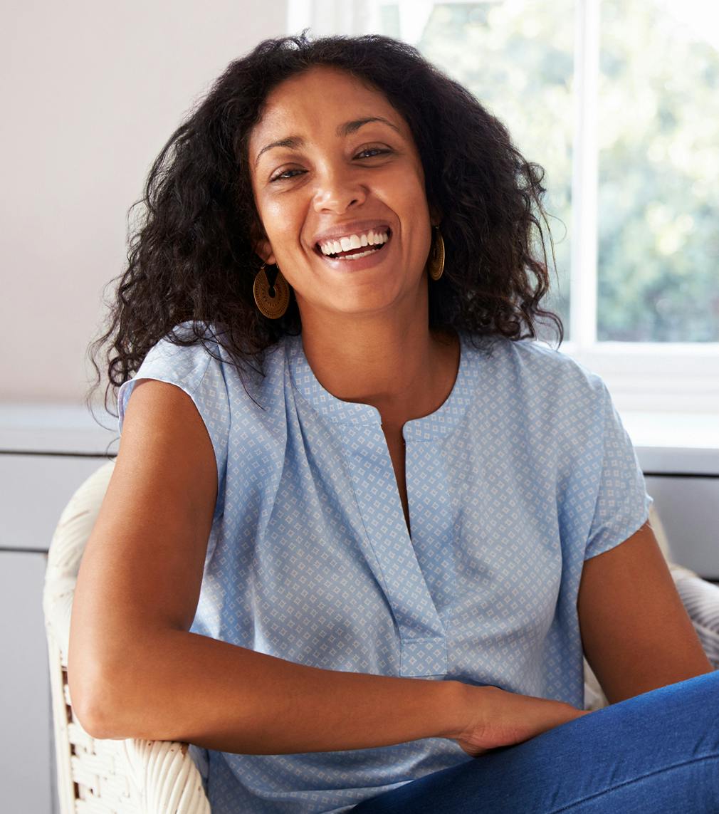 Woman in a blue top sitting down in a chair