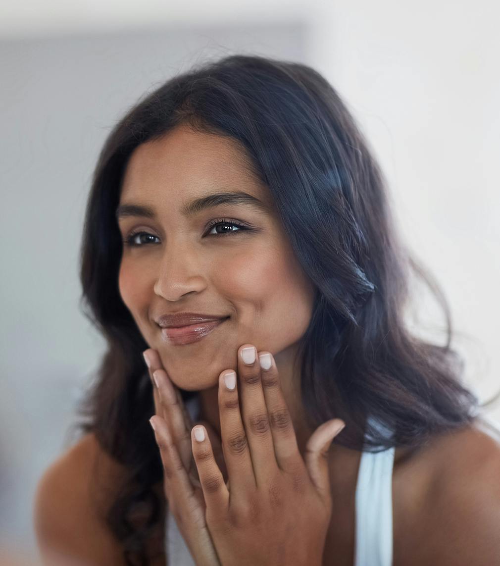 Woman with her hands on her chin smiling